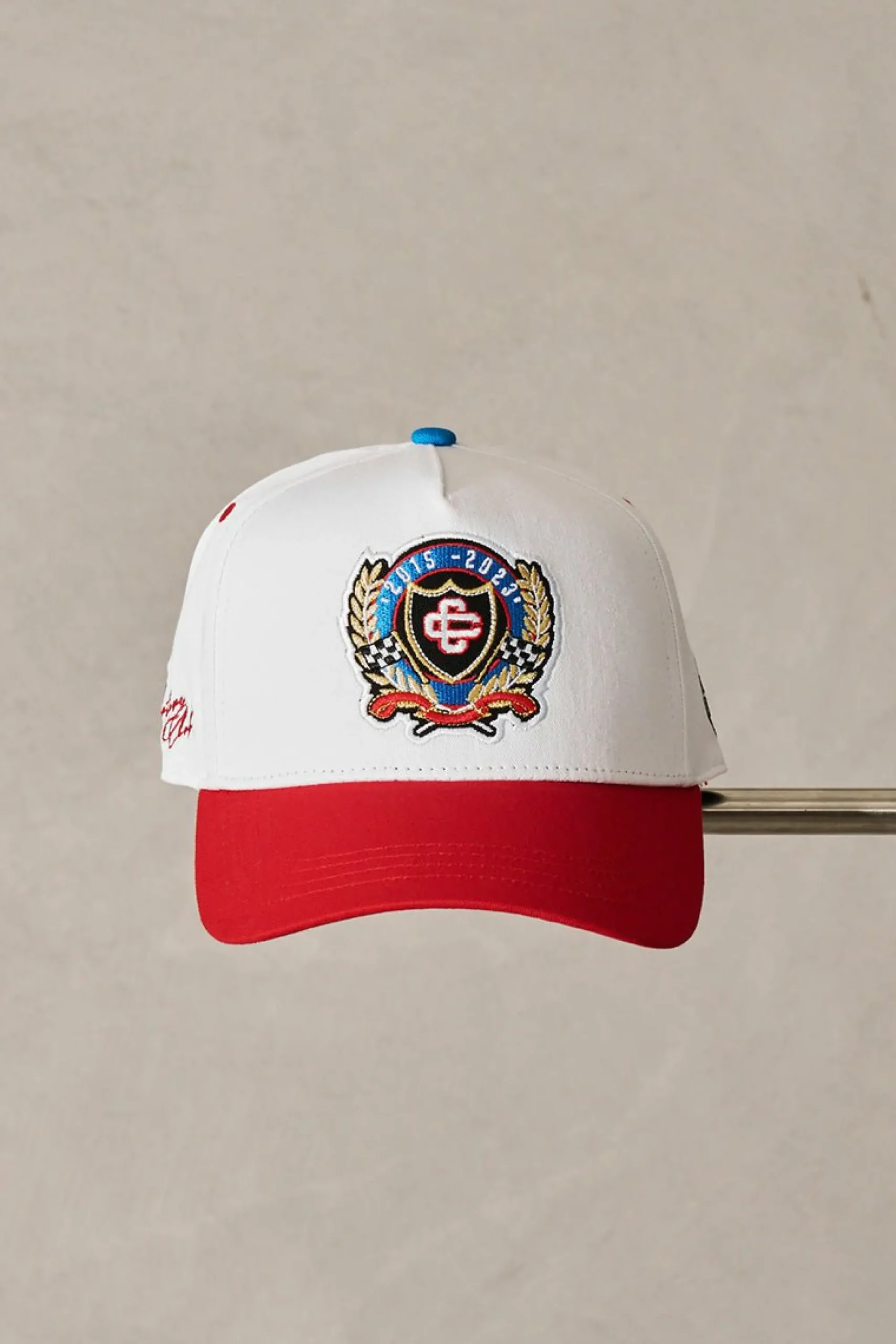 emblem_anniversary_badged_2.webp The Couture Club Caps & Hats-Emblem Anniversary Badged Cap